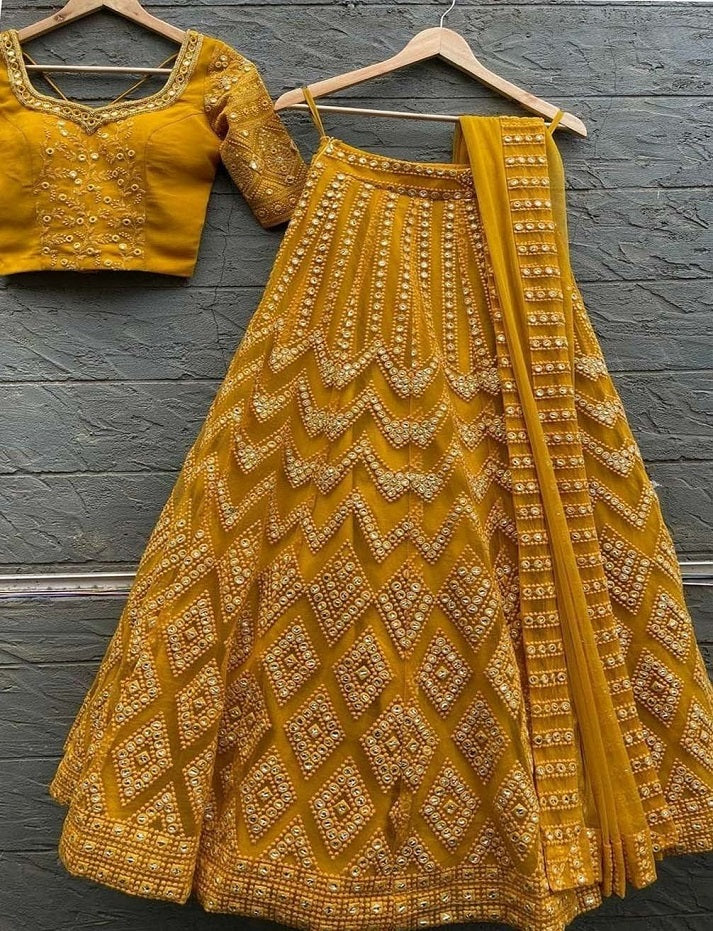 GOLDEN YELLOW EMBROIDERED ATTRACTIVE PARTY WEAR SILK LEHENGA CHOLI HAS A REGULAR-FIT AND IS MADE FROM HIGH-GRADE FABRICS AND YARN